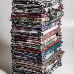 A stack of Paul Rucker-designed throws, based on historic postcards featuring lynching imagery