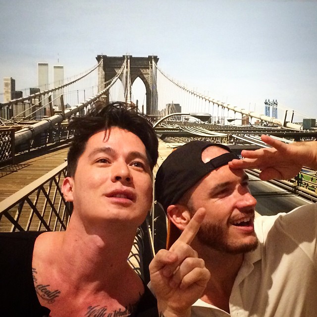 Instagrammers Andrew Yang (@yangabang) and Alex Ghinger (@alexghinger) pose with Richard Estes's <em>Brooklyn Bridge</em> (1993) at the Museum of Arts and Design. Photo: yangabang, via Instagram.