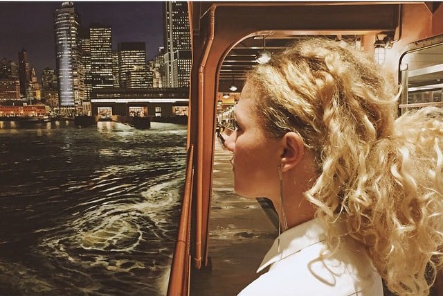 Instagrammer Kim Swift (@_kimswift_) poses with Richard Estes's Staten Island Ferry Arriving in Manhattan (2012) at the Museum of Arts and Design. Photo: Kim Swift (@_kimswift_).