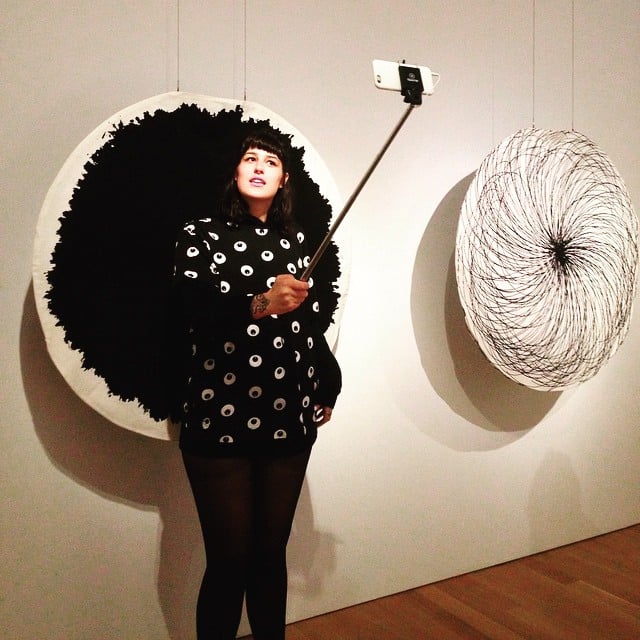 Instagrammer Allyee Whaley (@emotionalallyee) takes a selfie in front of Vuokko Eskolin Nurmesniemi's <em>Untitled (circle dress)</em> (circa 1964) in the "Pathmakers: Women in Art, Craft and Design, Midcentury and Today" exhibition at the Museum of Arts and Design.<br /> Photo: Sarah Cascone.