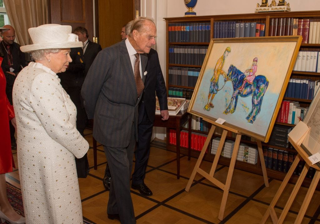 Queen Elizabeth II and Prince Philip, Duke of Edinburgh, inspect the Nicole Leidenfrost painting Horse in Royal Blue at a reception hosted by German President Joachim Gauck, at Schloss Bellevue palace on the second day of the royal couple's four-day visit to Germany on June 24, 2015 in Berlin, Germany.