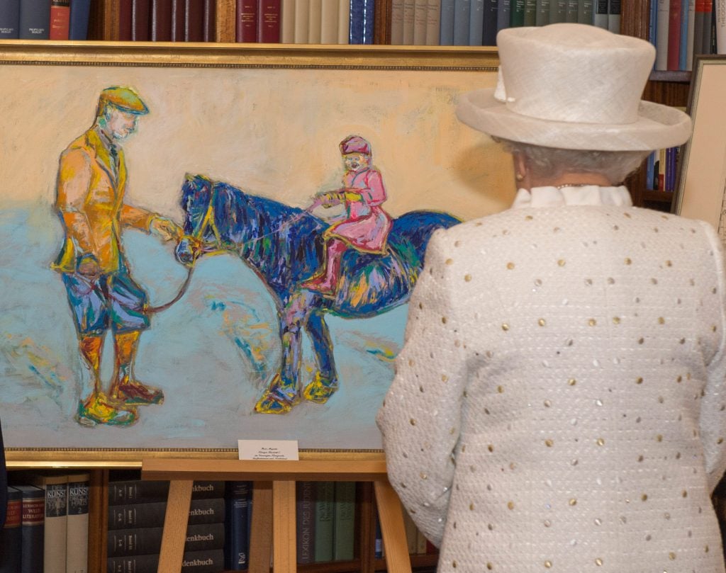 Queen Elizabeth II with a painting of her and father when she was a little girl, a gift from German President Joachim Gauck on a state visit to Berlin.