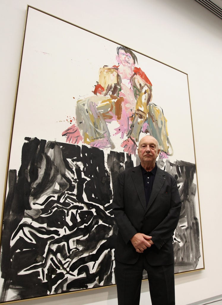 German painter Georg Baselitz poses in front of his painting 'Ein moderner Maler' (Remix) at the Berlinische Galerie on March 25, 2010 in Berlin, Germany. Photo by Andreas Rentz/Getty Images.