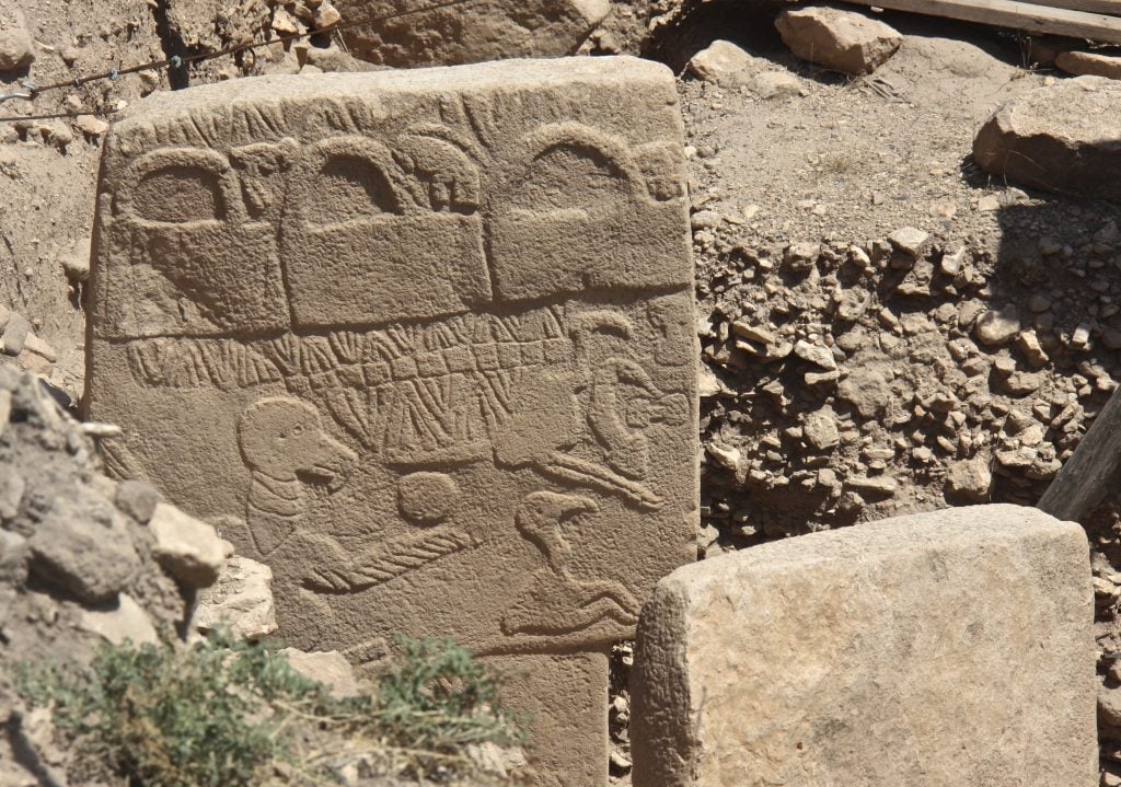 Archaeologists believe the Vulture Stone in Gobeklitepe, a Turkish archaeology site, may be the earliest example of writing. Photo by Sue Fleckney, Creative Commons Attribution-Share Alike 2.0 Generic license.