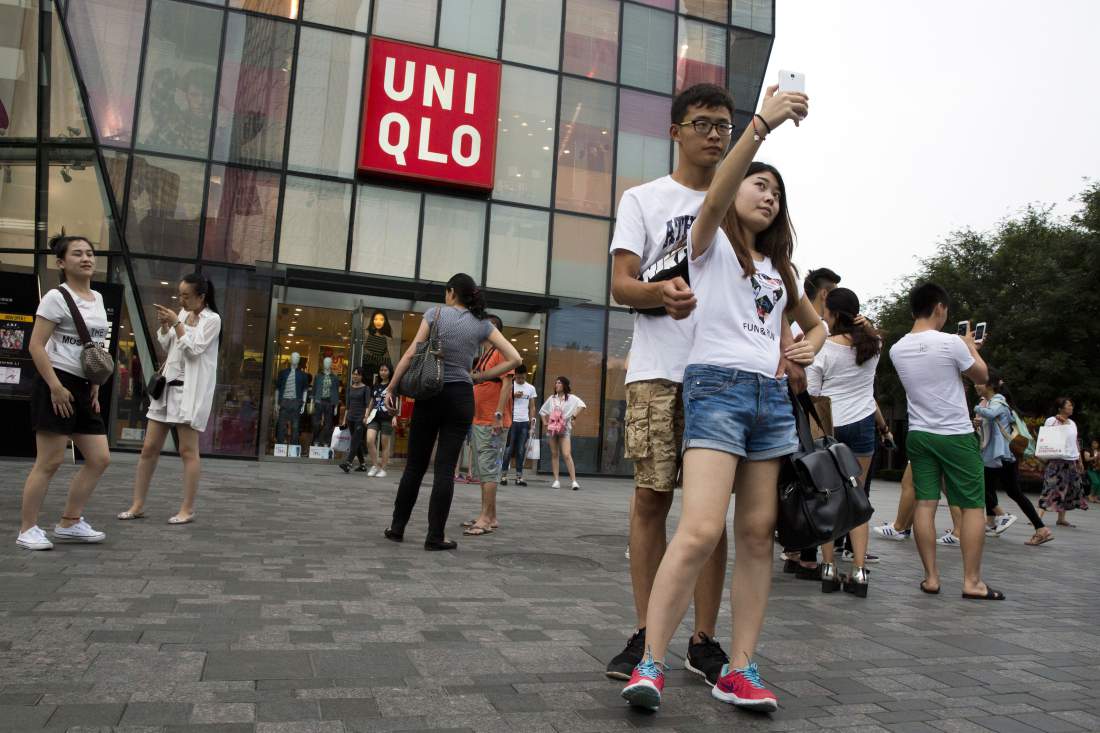Selfie madness proliferates outside the Beijing Uniqlo store thought to be the site of the dressing room where a viral sex tape was shot. Photo: Ng Han Guan, courtesy AP Photo.