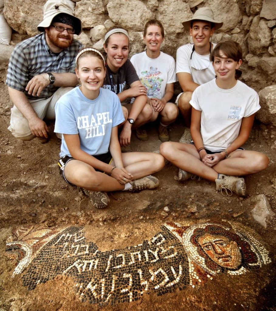 UNC professor Jodi Magness (center) and UNC students (left to right) Brian Coussens, Caroline Carter, Jocelyn Burney, Jonathan Branch, and Kelly Gagnon, with the 2012 Huqoq mosaic. Photo by Jim Haberman.