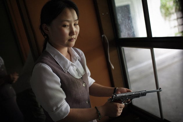 Tomas van Houtryve, A North Korean woman loads a pistol for firing practice in Pyongyang, North Korea (2007). Photo: Tomas van Houtryve.
