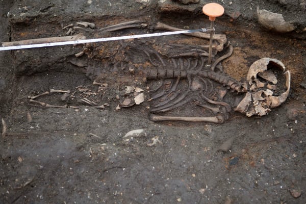 An adult and a baby skeleton lay uncovered at the Bedlam burial ground in London.