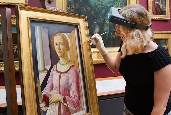 A V&A Conservator with Sandro Botticelli’s Portrait of a Lady known as Smeralda Bandinelli (circa 1470-5)Photo: via Art Daily