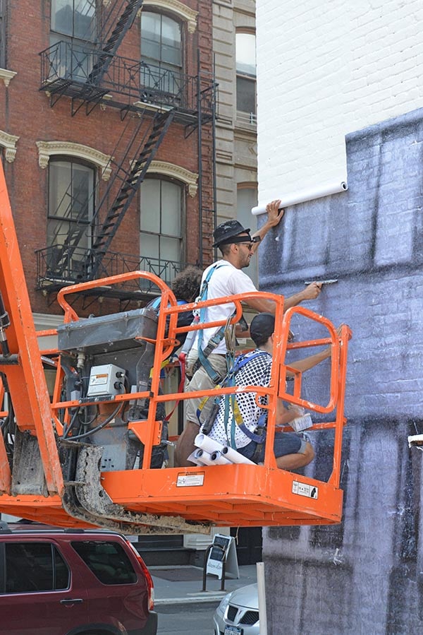 JR installing his art in Tribeca.  Photo: courtesy JR.