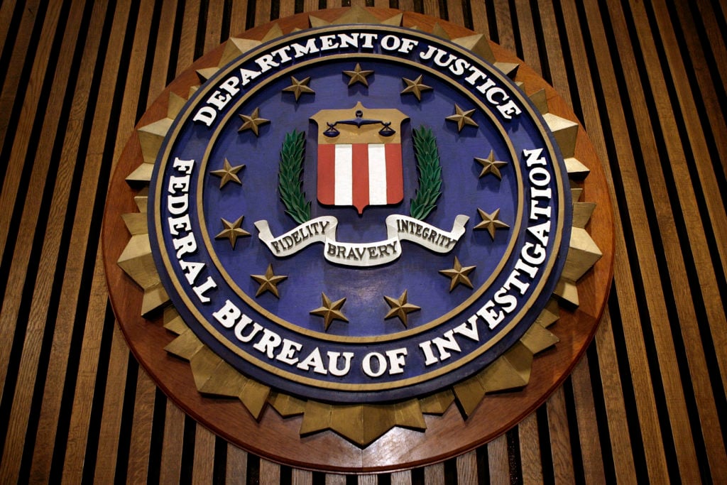 The seal of the FBI hangs in the Flag Room at the bureau's headquarters on March 9, 2007 in Washington, DC. (Photo by Chip Somodevilla/Getty Images)