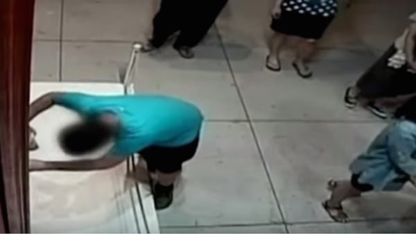 The moment when the 12-year-old boy punches the painting was recorded by CCTVPhoto: via YouTube