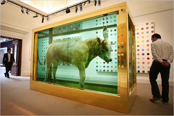 Visitors encounter “The Golden Calf” by Damien Hirst. Photo courtesy of Peter Macdiarmid/Getty Images.