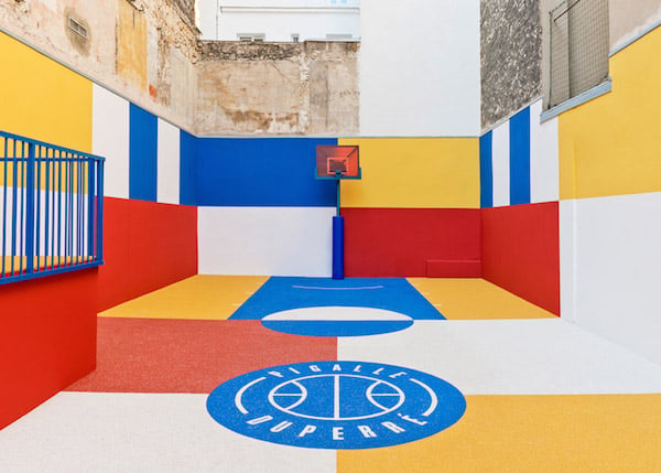 The brightly colored court is contrasted against the urban landscape. Photo: DeZeen