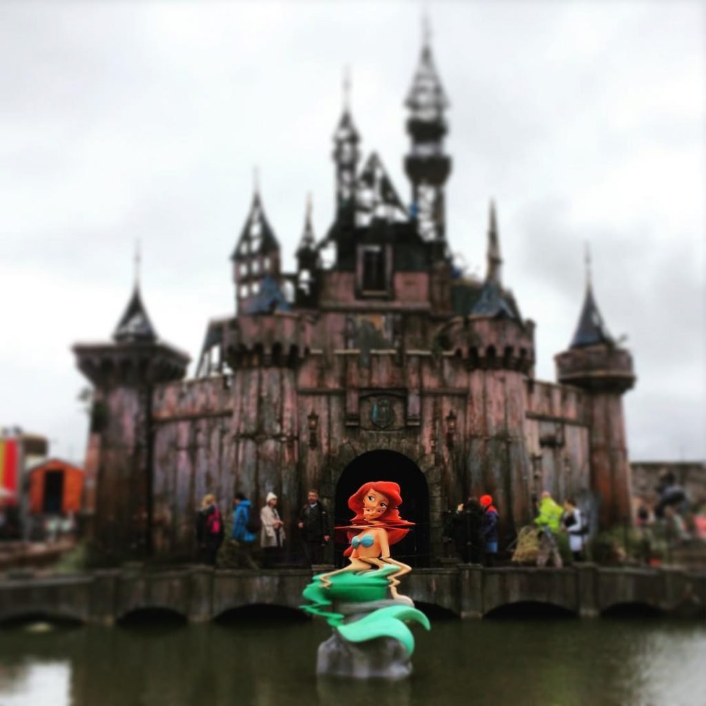 Banksy's twisted Cinderella's Castle at Dismaland. Photo by Florent Darrault, Creative Commons Attribution-Share Alike 2.0 Generic license.