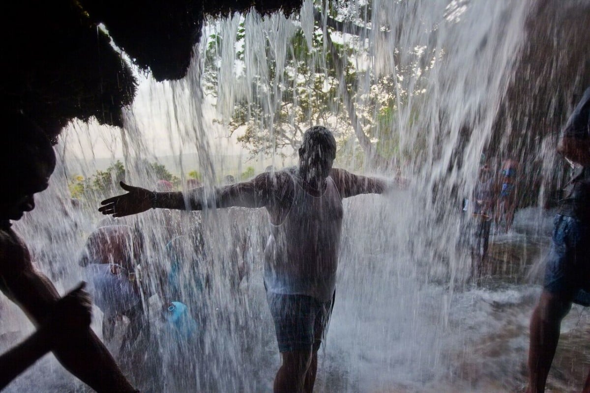 John Stanmeyer, Haiti, 2009. Vodou and Christianity meld at the Saut d’Eau waterfall in Ville Bonheur, Haiti, where believers pray to the Virgin Mary and welcome spirits said to inhabit the falls. Photo: John Stanmeyer.