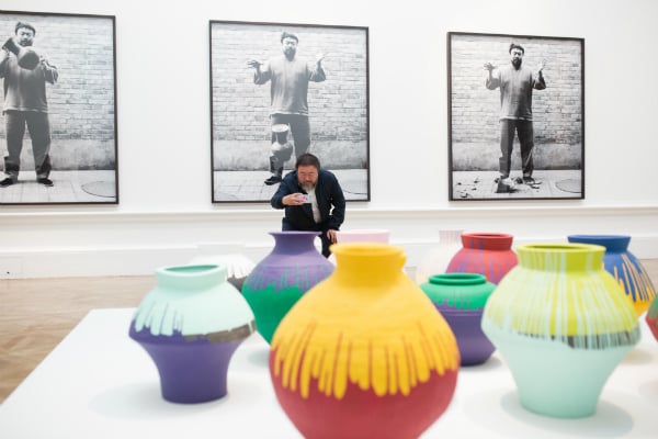 Ai Weiwei taking a photograph of his installation Coloured Vases, Royal Academy of Arts, 2015.<br>Photo: © Dave Parry Courtesy Royal Academy of Arts, London.