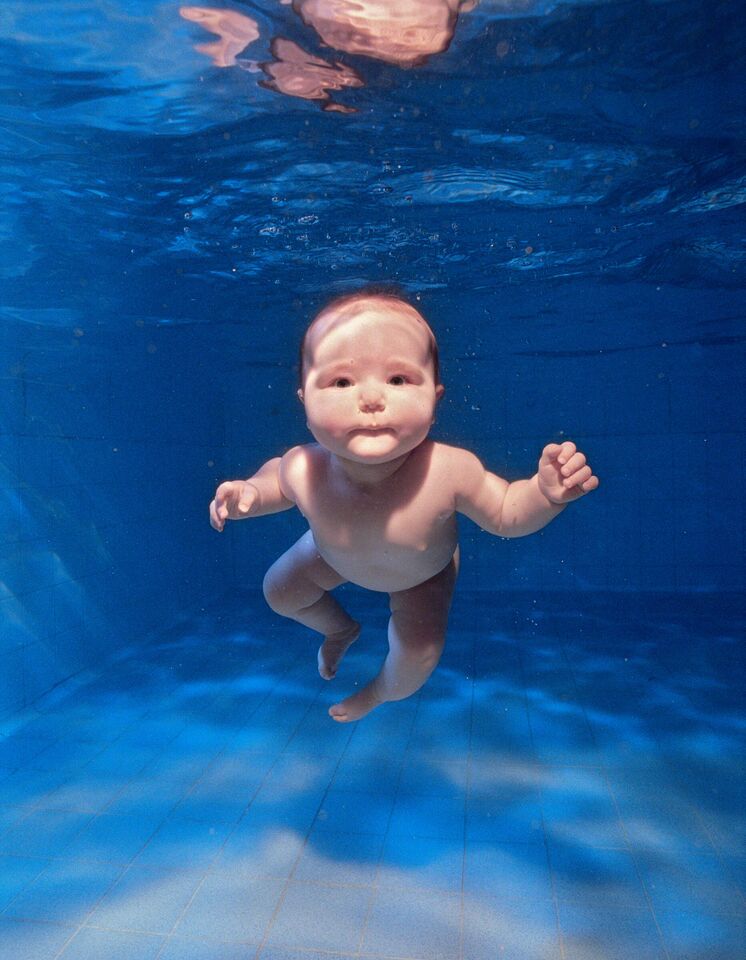 Zena Holloway, England, 2003. An underwater portrait captures the buoyancy of babies, who are three-fourths water. That fraction becomes two-thirds as we age, yet our vital fluids remain saline, like the oceans from which life sprang. Photo: Zena Holloway, Getty Images.