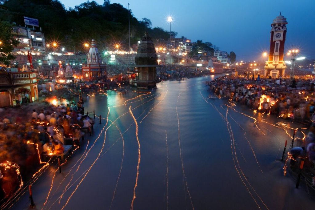 John Stanmeyer, VII, India, 2009. India’s holiest river, the Ganges, is scribbled with light from floating oil lamps during the Ganga Dussehra festival in Haridwar. Hindus near death often bathe in the river; some are later cremated beside it and have their ashes scattered in its depths. Photo: John Stanmeyer, VII.