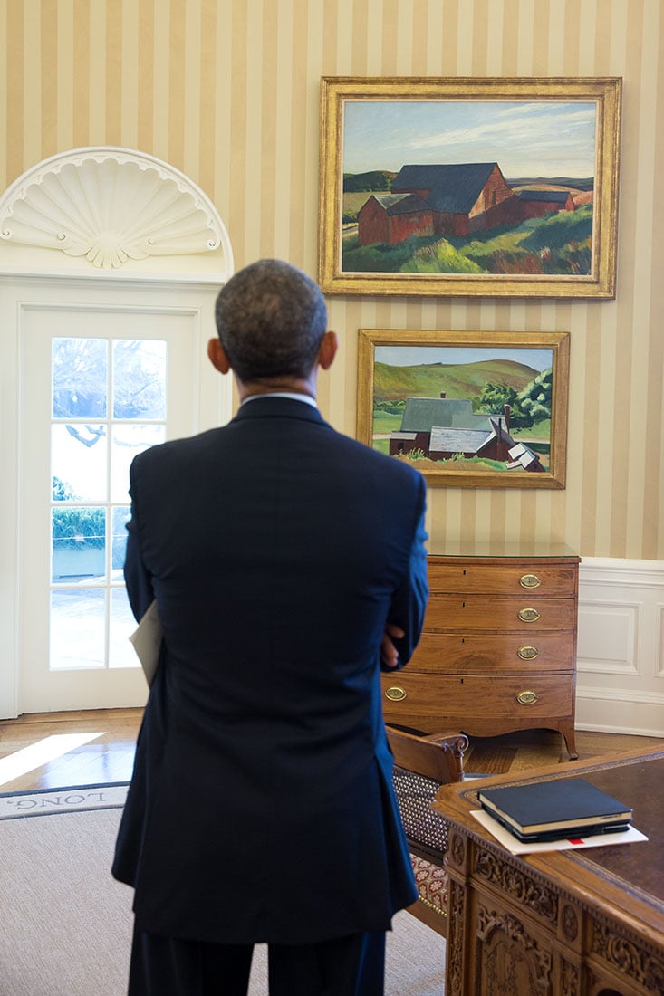 President Barack Obama looks at the Edward Hopper paintings, Cobb's Barns, South Truro, top, and Burly Cobb's House, South Truro, now displayed in the Oval Office. Photo: Chuck Kennedy, courtesy the White House.