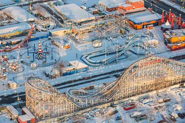 George Steinmetz, "New York Air." Coney Island’s Luna Park hibernates under a soft blanket of snow. The Cyclone roller coaster in the foreground, dating from 1927, is one of three New York City landmark rides in the area. Photo: George Steinmetz, courtesy Anastasia Photo.
