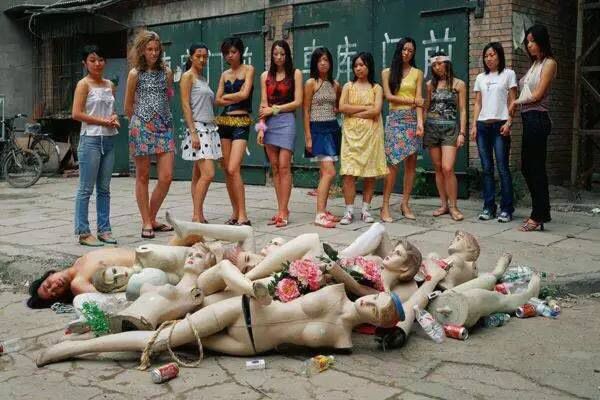 A photo by Liu Jing depicting women staring at broken manikins and a topless man. Photo: Wechat/Cangjia via Quartz