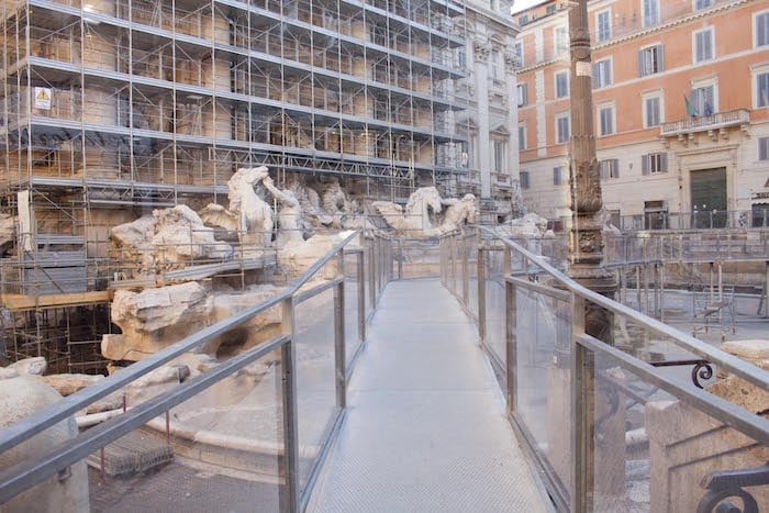 During restoration, the Trevi Fountain was obscured by scaffolding, and accessible by a walkway. Photo by Fendi for Fountains. 