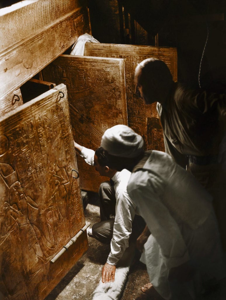 Harry Burton, Howard Carter, Arthur Callender and an Egyptian worker entering the innermost shrine to see King Tut's sarcophagus for the first time. Photo: courtesy the Griffith Institute, colorization by Dynamichrome.