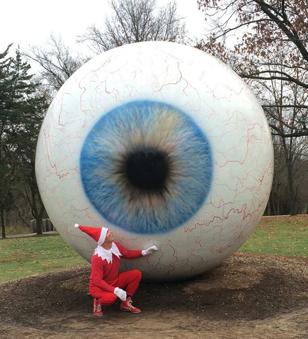 Pat Waterkotte as the Creepy Elf with Tony Tasset's Eye in Laumeier Park, St. Louis. Photo: Dawn Boly.