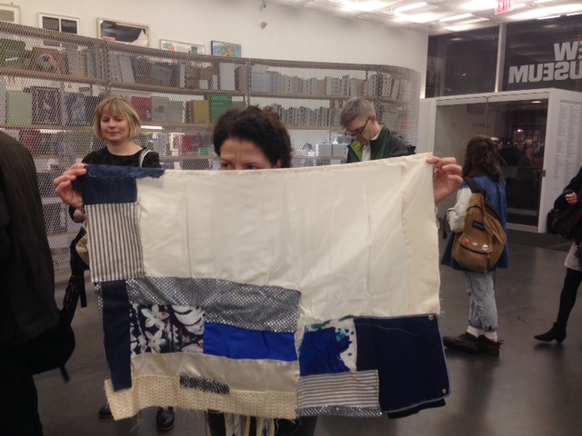 Mary Barone brings a quilt created with artist Susan Cianciolo to “Pia Camil: A Pot for a Latch” Exchange Day, December 18, 2015, at the New Museum, New York. Photo: Sarah Cascone.