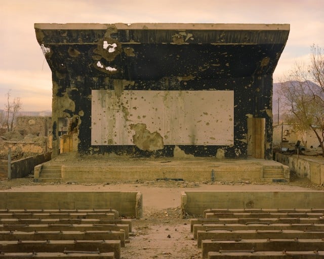 Simon Norfolk. Bullet-scarred outdoor cinema at the Palace of Culture in the Karte Char district of Kabul, 2002. Edition of 10. Digital C-print. 40 x 50 inches. Collection of Dr. and Mrs. J. Patrick Kennedy. Image courtesy of Simon Norfolk/Benrubi Gallery. On view in the exhibition "Walkers: Hollywood Afterlives in Art and Artifact" at Museum of the Moving Image, November 7, 2015–April 10, 2016.