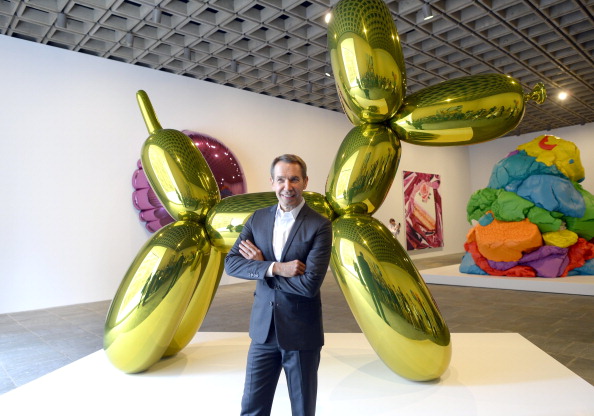 Artist Jeff Koons poses next to one of his sculptures during a press preview of "Jeff Koons: A Retrospective" a exhibition of his work at the Whitney Museum of American Art June 24, 2014. Photo: Timothy A. Clary /AFP/Getty Images.