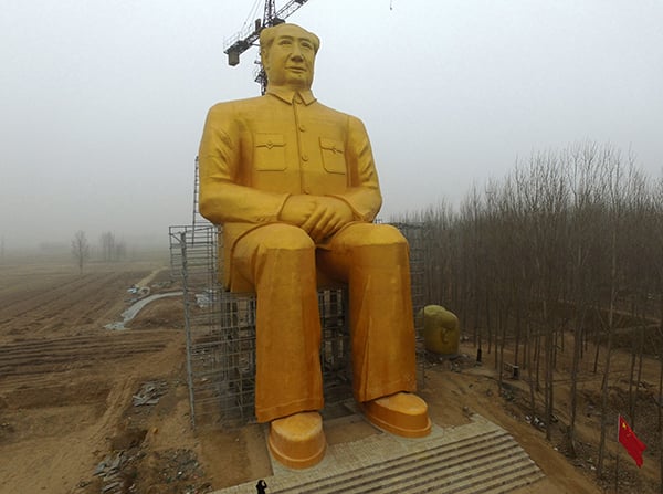 This photo taken on January 4, 2016 shows a huge statue of Chairman Mao Zedong under construction in Tongxu county in Kaifeng, central China's Henan province. The statue reportedly measures 120 feet (36.6meters) in height and is located in Zhushigang village. Photo: STR/AFP/Getty Images.