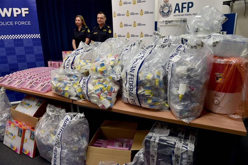 Border Police officers stand next to a haul of crystal methamphetamine concealed in packaging at the Australian Federal Police headquarters in Sydney on February 15, 2016. Australian police have seized more than 712 million USD in crystal methamphetamine, or ice, some concealed in gel bra inserts in one of the country's biggest drug busts. Photo" SAEED KHAN/AFP/Getty Images.