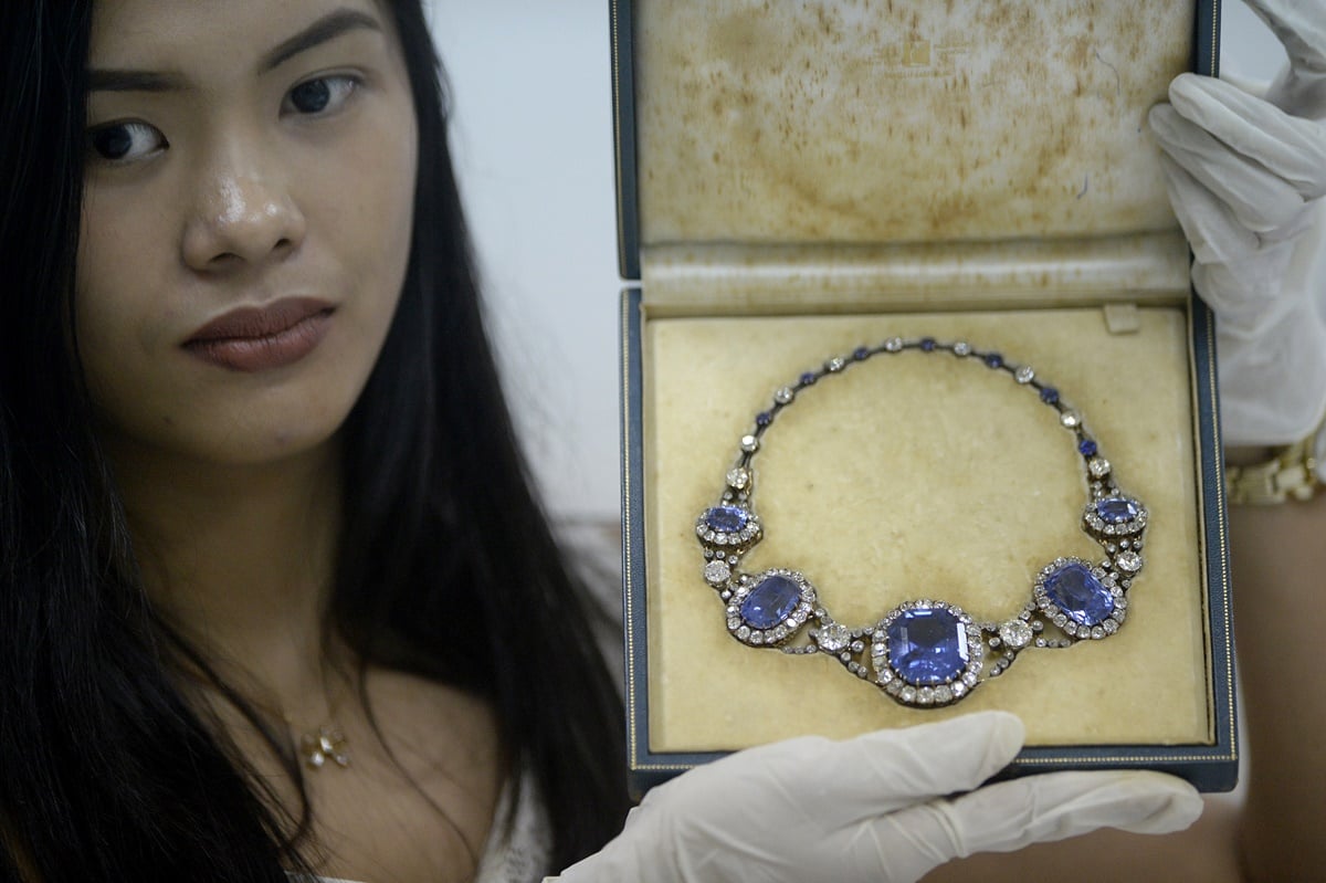 An official from the Presidential Commission on Good Government (PCGG) shows a piece of jewellery seized by the Philippine government from former first lady Imelda Marcos, at the Central Bank headquarters in Manila on November 27, 2015. Philippine authorities had the dazzling collection appraised by auction houses for a second day, ahead of a possible sale. AFP PHOTO / NOEL CELIS / AFP / NOEL CELIS (Photo credit should read NOEL CELIS/AFP/Getty Images)