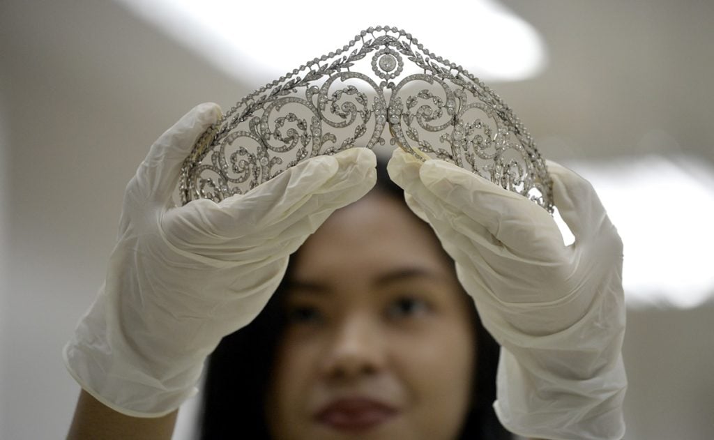 An official from the Presidential Commission on Good Government (PCGG) shows a piece of jewellery seized by the Philippine government from former first lady Imelda Marcos, at the Central Bank headquarters in Manila on November 27, 2015. Philippine authorities had the dazzling collection appraised by auction houses for a second day, ahead of a possible sale. AFP PHOTO / NOEL CELIS / AFP / NOEL CELIS (Photo credit should read NOEL CELIS/AFP/Getty Images)