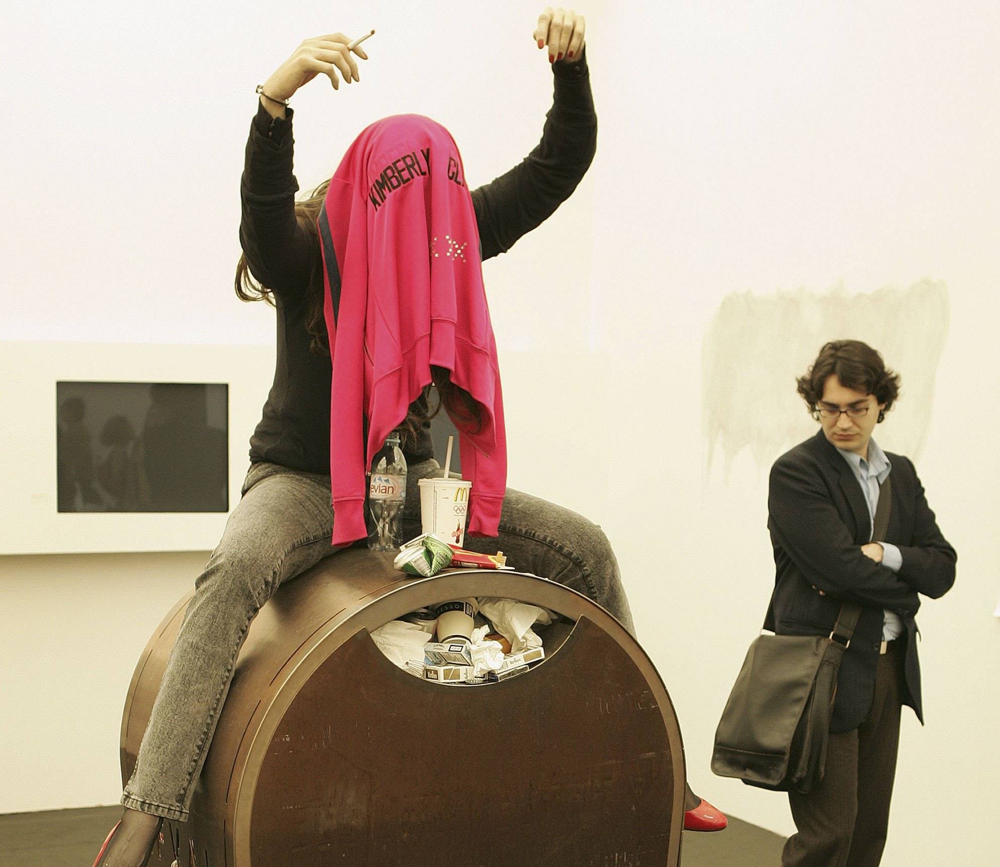 LONDON - OCTOBER 12: A visitor to the Frieze Art Fair ooks at a mannequin sitting on a trash can on October 12, 2006 in London, England. The fair is held every October in London's Regent's Park and features over 160 contemporary art galleries and a sculpture park. (Photo by Peter Macdiarmid/Getty Images)