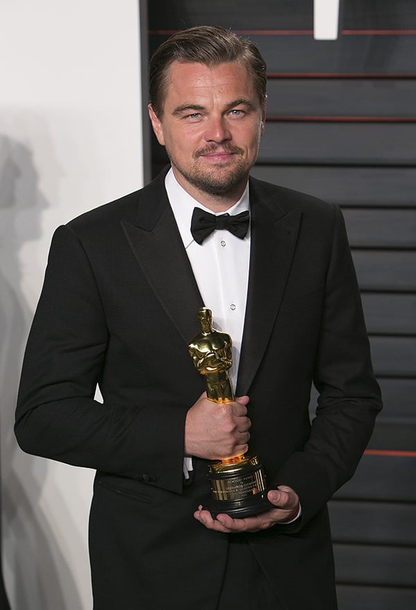 Actor Leonardo DiCaprio poses with his Best Actor award for the Revenant as he arrives to the 2016 Vanity Fair Oscar Party in Beverly Hills, California on February 28, 2016.Photo: Adrian Sanchez-Gonzalez/AFP/Getty Images.