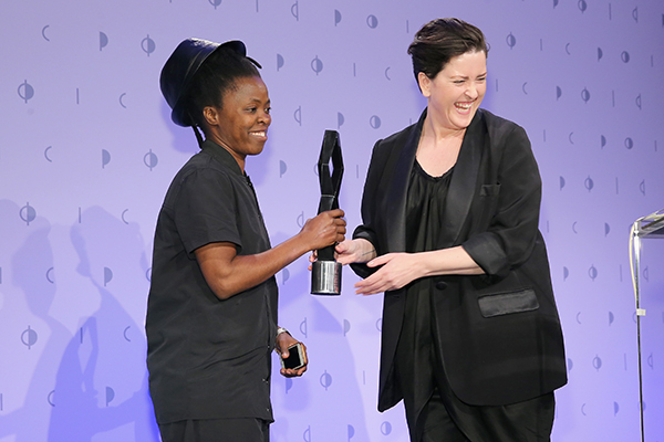 Honoree, photographer Zanele Muholi accepts an award from Charlotte Cotton during the International Center of Photography's 2016 Infinity Awards. <br>Photo: Jemal Countess/Getty Images for International Center of Photography.