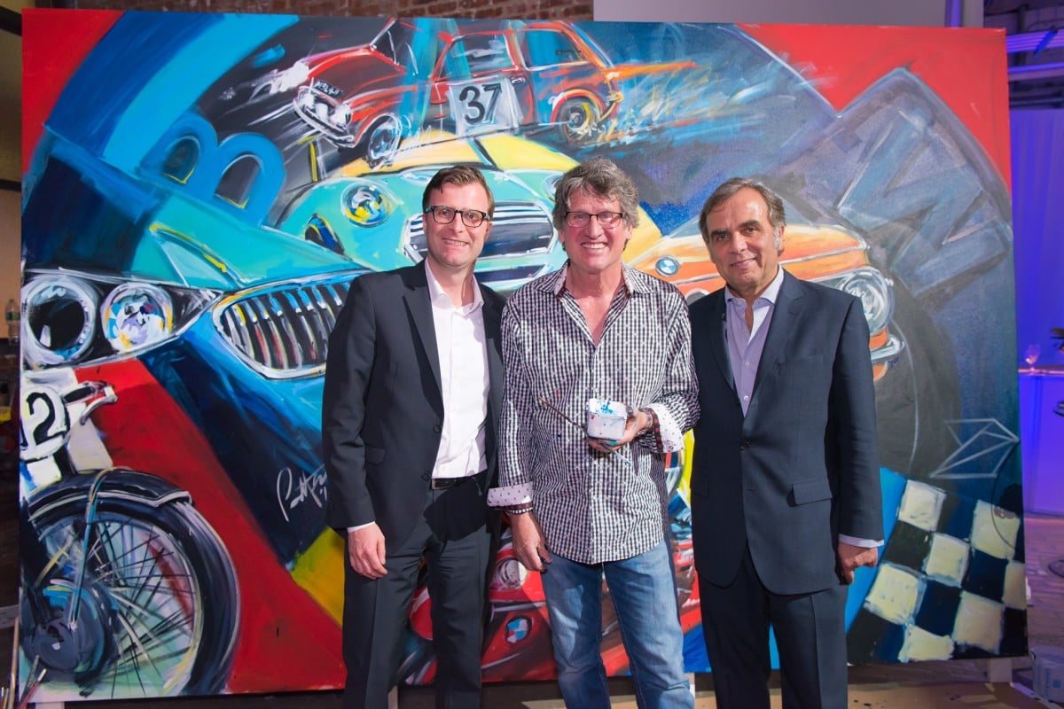 Alexander Bilgeri, Bill Patterson, and BMW North America CEO Ludwig Willisch with the painting Patterson created from start to finish during the BMW Group's three-hour 100th anniversary party. <br>Photo: courtesy BMW.