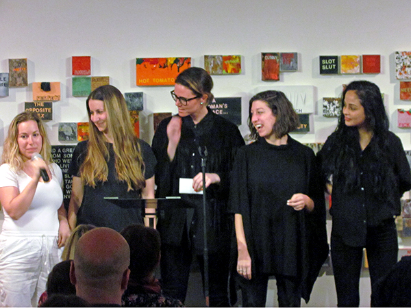 Minerva performing at "Words on WOMEN," an open mic night at Chelsea's FLAG Art Foundation celebrating Betty Tompkins's exhibition, "WOMEN Words, Phrases, and Stories: 1,000 Paintings." <br>Photo: courtesy FLAG Art Foundation. 