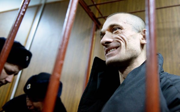 Russian artist Pyotr Pavlensky smiles during a hearing at a court in Moscow on February 26, 2016.Photo: Dmitry Serebryakov/AFP/Getty Images.