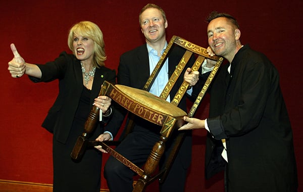 Actress Joanna Lumley, Miles Apthorp, and actor Rory Bremner with J.K. Rowling's Harry Potter chair at the Chairish the Child charity auction held at Christie's on September 4, 2002 in London, England.  Miles Apthorp placed the winning bid.<br>Photo: Scott Barbour/Getty Images.