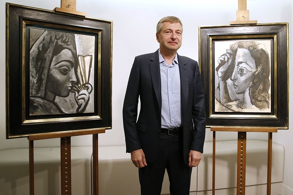 Dmitry Rybolovlev poses in front of two allegedly stolen paintings by Pablo Picasso, 