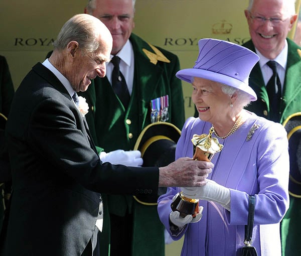 Queen Elizabeth II's horse Estimate wins the Queen's vase on the fourth day of Royal Ascot and she is presented with her trophy by her husband the Duke of Edinburgh. <br>Photo: Mark Stewart.