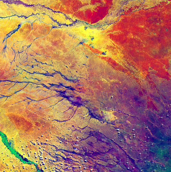 <em>A Study in Color</em>, "Earth as Art," July 15, 2014. <br>The deep purple in the lower right spreads out into a few channels before fading into a multitude of colors. These channels are remnants of an ancient drainage network in Kenya. The beauty of the colors actually hides a stark reality for hundreds of thousands of people. The dark spots at the top center of the image are refugee camps. <br>Photo: USGS.