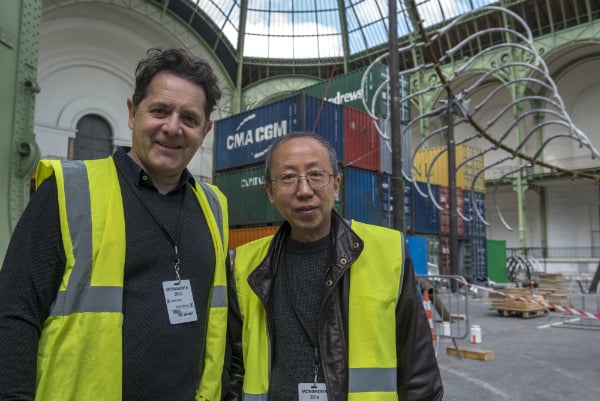 Huang Yong Ping and Jean de Loisy during the installation of "Empires". MONUMENTA 2016. Photo:Didier Plowy/Rmn ©Adagp, Paris 2016 courtesy of the artist and Kamel Mennour, Paris