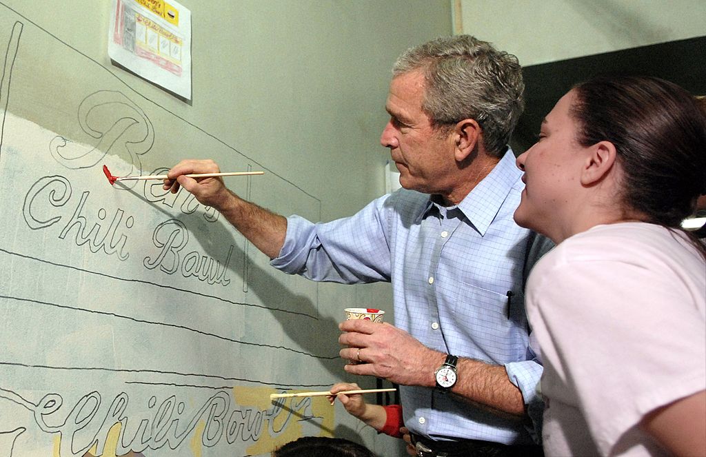 WASHINGTON - JANUARY 15: (AFP OUT) U.S. President George W. Bush helps paint a mural along side City Year volunteer Morgan Lacey, as part of a community service activity at Cardozo High School January 15, 2007 in Washington, DC. (Photo by Kevin Dietsch-Pool/Getty Images)