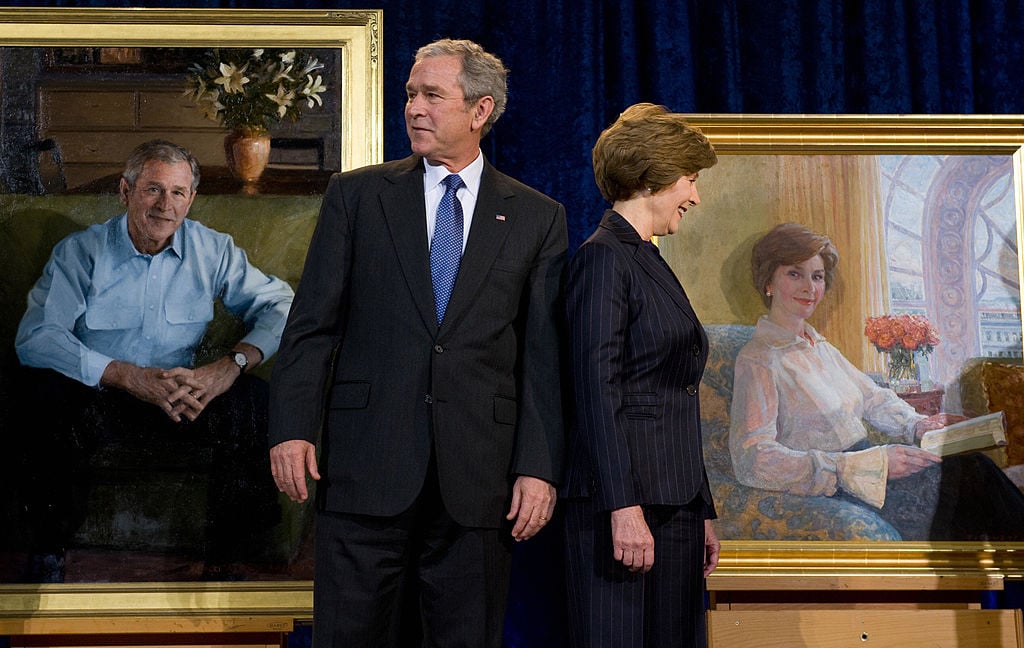 US President George W. Bush stands beside First Lady Laura Bush during the unveiling of their National Portrait Gallery portraits at the National Portrait Gallery in Washington, DC, on December 19, 2008. Bush's painting is by Robert Anderson, with the First Lady's by Aleksander Titovets. AFP PHOTO / Saul LOEB (Photo credit should read SAUL LOEB/AFP/Getty Images)