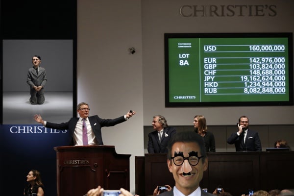 Christie's Global President and auctioneer Jussi Pylkkanen gestures during the bidding of Pablo Picasso's Women of Algiers (Version O), which sold for nearly $179.4 million, making it set a world record for artwork at auction during a sale at Christie's Rockefeller Center in New York, Monday, May 11, 2015. Experts say high art prices are driven by artworks' investment value and by wealthy new and established collectors seeking out the very best works. (AP Photo/Kathy Willens)